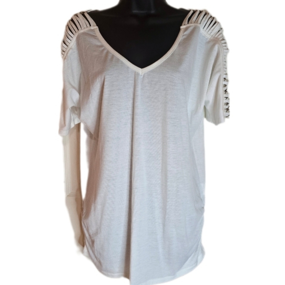 White top with peekaboo sleeves with metal accents.